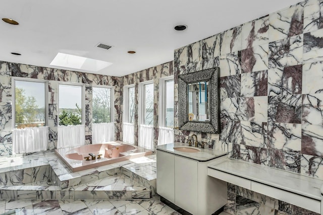 9 Dock Ln, Kings Point, NY 11024 - full bath featuring a skylight, a bath, vanity, recessed lighting, and marble tiled flooring