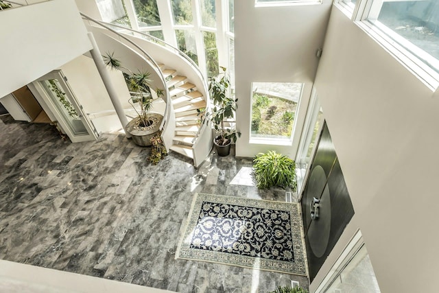9 Dock Ln, Kings Point, NY 11024 - staircase featuring a high ceiling and marble tiled floors