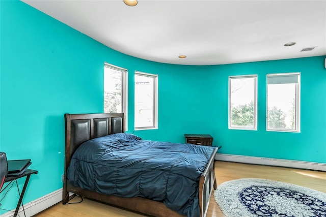 9 Dock Ln, Kings Point, NY 11024 - bedroom featuring light wood-style floors, baseboard heating, multiple windows, and recessed lighting