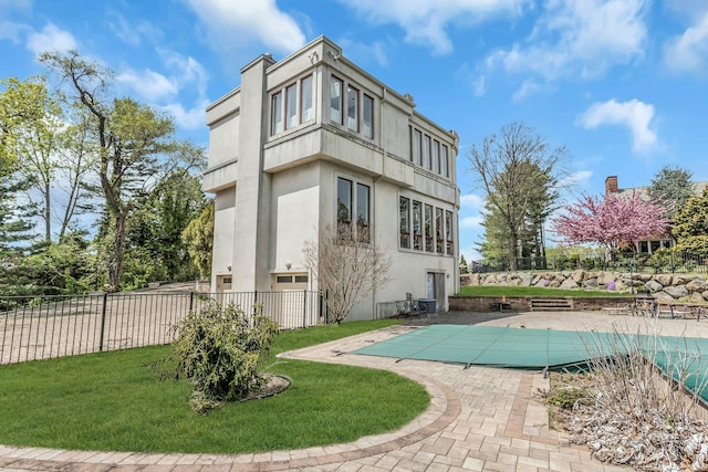 9 Dock Ln, Kings Point, NY 11024 - back of property featuring stucco siding and a patio