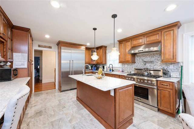 258 Longstreet Ave, Bronx, NY 10465 - kitchen with a sink, brown cabinets, under cabinet range hood, decorative backsplash, and high quality appliances