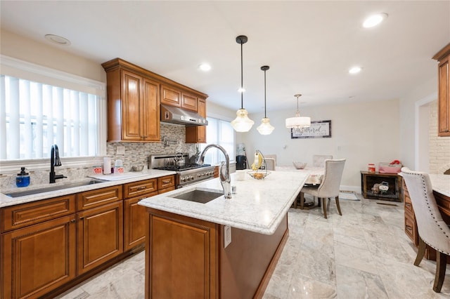 258 Longstreet Ave, Bronx, NY 10465 - kitchen featuring gas stove, brown cabinetry, under cabinet range hood, and a sink