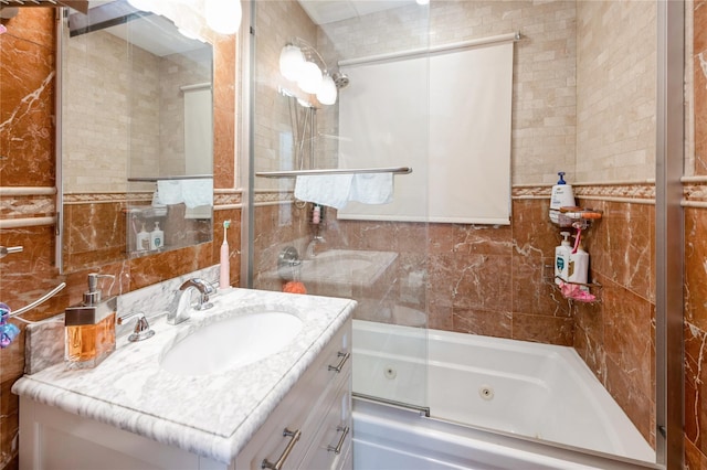 258 Longstreet Ave, Bronx, NY 10465 - bathroom featuring tile walls, a combined bath / shower with jetted tub, and vanity