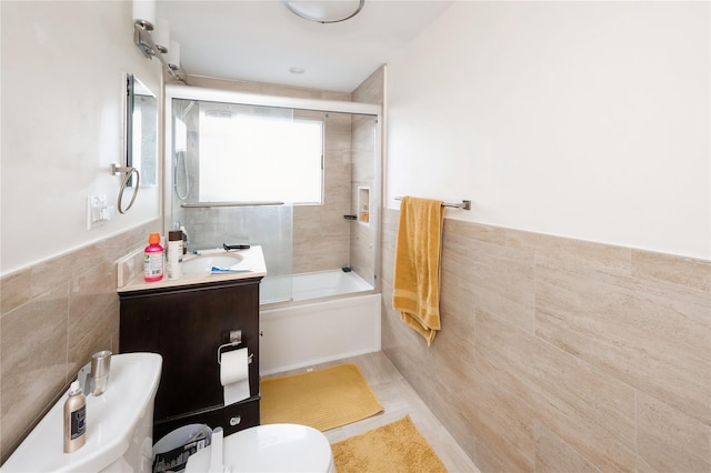 258 Longstreet Ave, Bronx, NY 10465 - bathroom featuring wainscoting, toilet, shower / bath combination with glass door, and tile walls