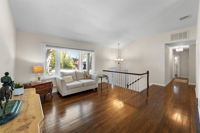 living area with hardwood / wood-style flooring, a chandelier, baseboards, and lofted ceiling