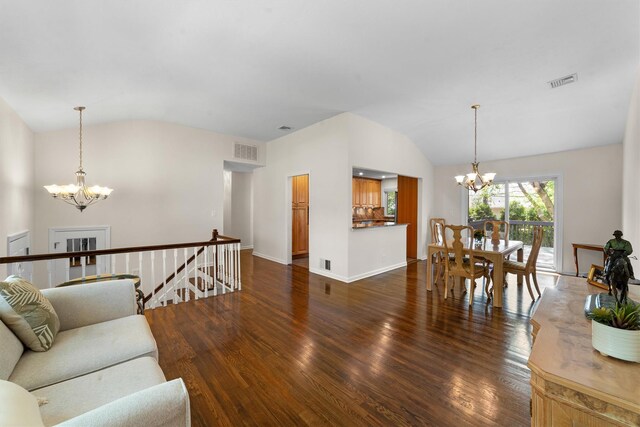 living room featuring a chandelier, vaulted ceiling, wood finished floors, and baseboards