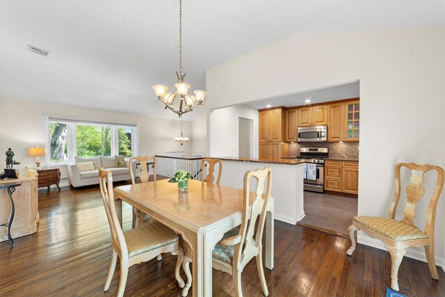 dining space featuring a chandelier, lofted ceiling, and dark wood-style floors