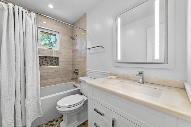 bathroom featuring toilet, shower / tub combo with curtain, vanity, and recessed lighting