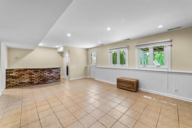 spare room featuring light tile patterned floors, a wainscoted wall, and recessed lighting