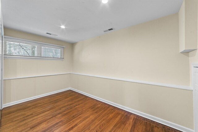 unfurnished room featuring wood finished floors, baseboards, and recessed lighting