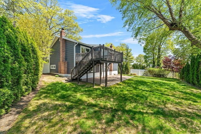 back of property featuring stairway, a deck, a chimney, and a patio area