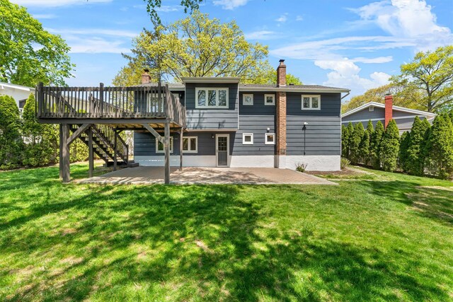 back of property featuring a patio area, stairs, a chimney, a wooden deck, and a yard