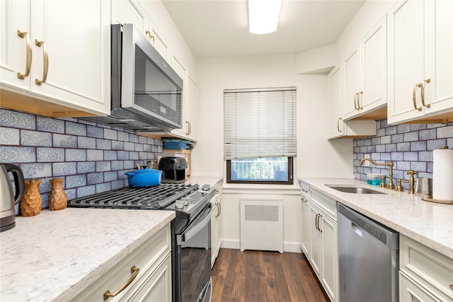 1203 E Broadway Unit G11, Hewlett, NY 11557 - kitchen with a sink, dark wood-style flooring, appliances with stainless steel finishes, and tasteful backsplash