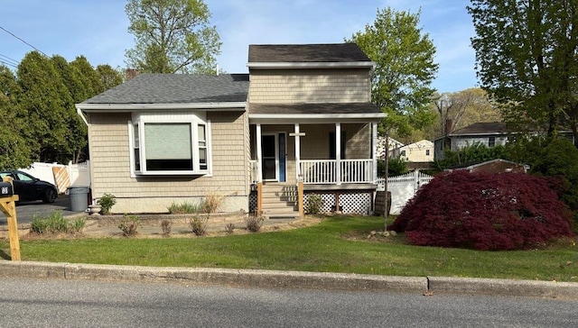 bungalow-style house with a chimney, a shingled roof, a front yard, fence, and a porch