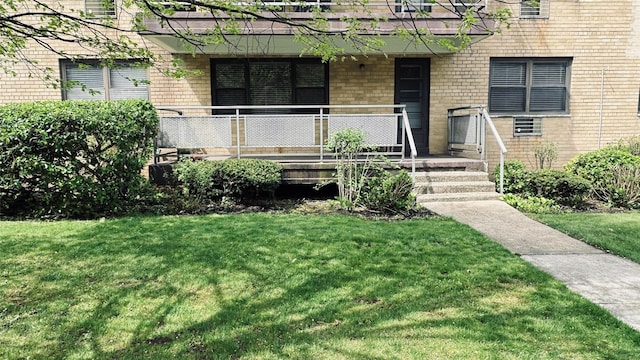 40 Stoner Ave Unit 1S, Great Neck, NY 11021 - entrance to property with a yard, brick siding, and covered porch