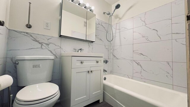 40 Stoner Ave Unit 1S, Great Neck, NY 11021 - full bathroom with vanity, tile walls, toilet, and shower / washtub combination