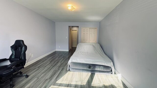 40 Stoner Ave Unit 1S, Great Neck, NY 11021 - bedroom featuring baseboards and dark wood finished floors