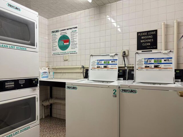 40 Stoner Ave Unit 1S, Great Neck, NY 11021 - community laundry room featuring stacked washer and clothes dryer and tile walls