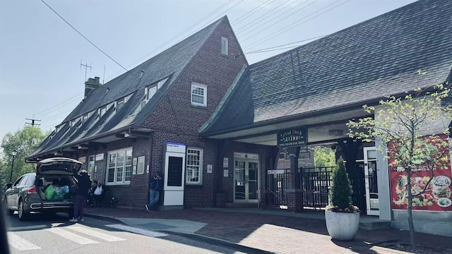 40 Stoner Ave Unit 1S, Great Neck, NY 11021 - exterior space featuring brick siding and a chimney