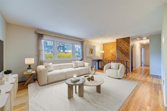 living room featuring wooden walls and light wood-style floors