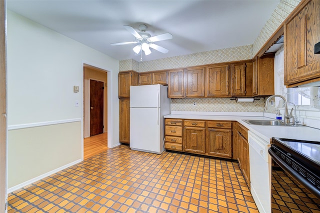 kitchen featuring a sink, tasteful backsplash, white appliances, and light countertops