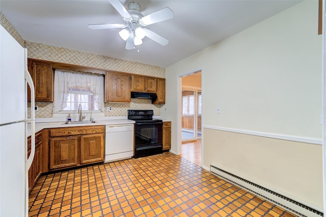 kitchen featuring a sink, white appliances, light countertops, range hood, and a baseboard radiator