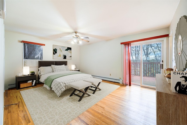 bedroom featuring access to outside, ceiling fan, a baseboard heating unit, and wood finished floors
