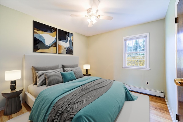 bedroom with wood finished floors, a ceiling fan, baseboards, and a baseboard heating unit