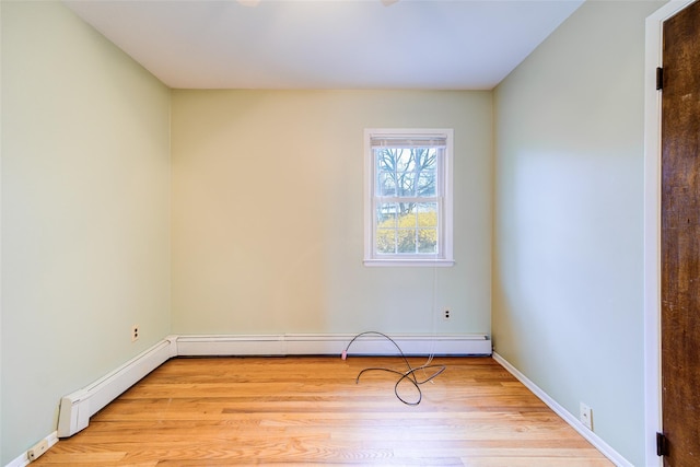empty room with baseboards and light wood-style floors