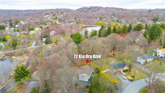 birds eye view of property featuring a residential view and a water and mountain view