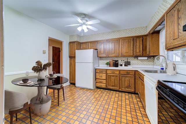 kitchen featuring a sink, white appliances, light countertops, a ceiling fan, and decorative backsplash
