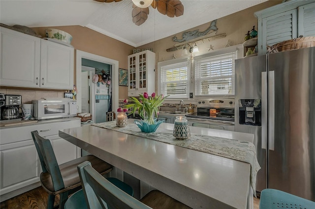 46 Satinwood Rd, Rocky Point, NY 11778 - kitchen featuring stainless steel appliances, ceiling fan, white cabinets, glass insert cabinets, and a breakfast bar