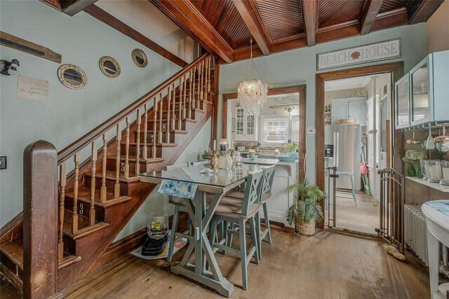 46 Satinwood Rd, Rocky Point, NY 11778 - dining space featuring a chandelier, stairway, hardwood / wood-style flooring, and a wooden ceiling with exposed beams