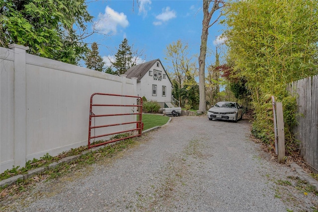 46 Satinwood Rd, Rocky Point, NY 11778 - view of dirt / gravel driveway with a gated entry