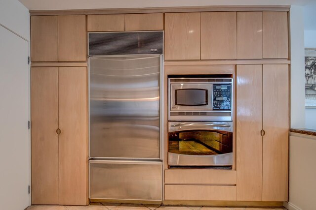 21629 28th Ave, Bayside, NY 11360 - kitchen with light brown cabinetry and built in appliances