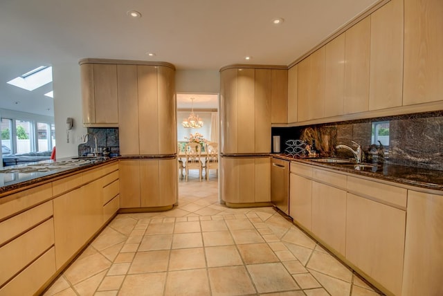 21629 28th Ave, Bayside, NY 11360 - kitchen with an inviting chandelier, decorative backsplash, recessed lighting, a sink, and a skylight