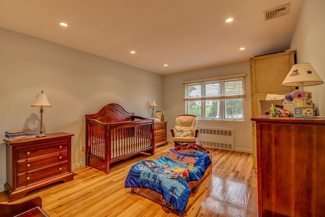21629 28th Ave, Bayside, NY 11360 - bedroom with light wood finished floors, radiator, recessed lighting, baseboards, and visible vents