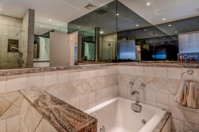 21629 28th Ave, Bayside, NY 11360 - full bathroom featuring a jetted tub, tile walls, a shower stall, and visible vents