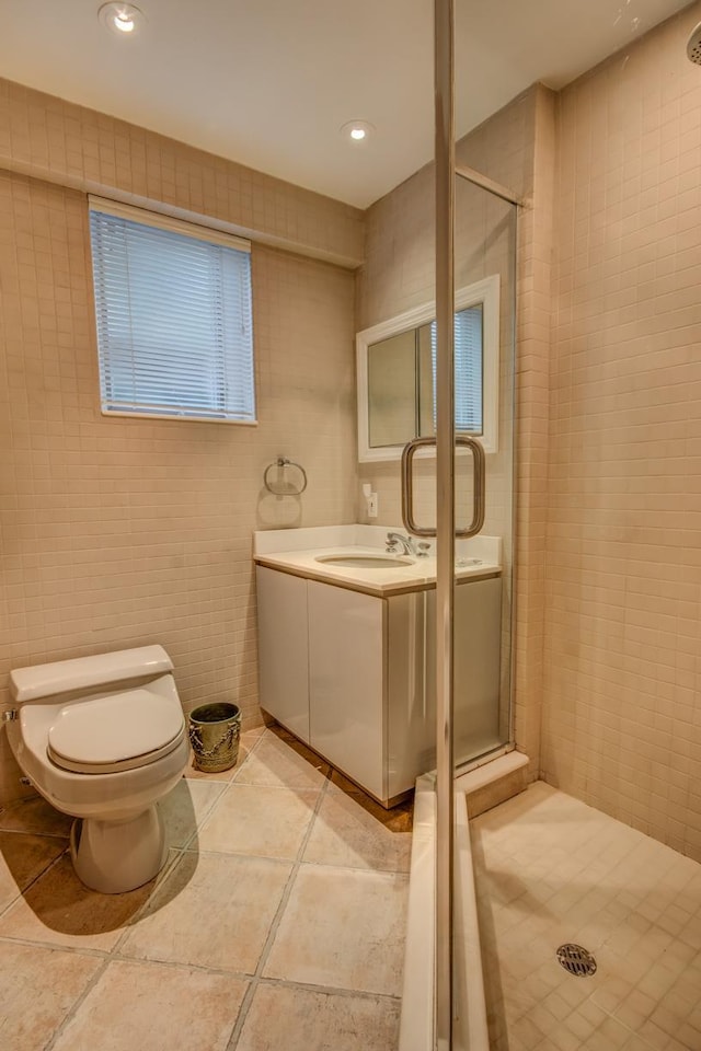 21629 28th Ave, Bayside, NY 11360 - full bath featuring vanity, toilet, tile walls, tile patterned floors, and a stall shower