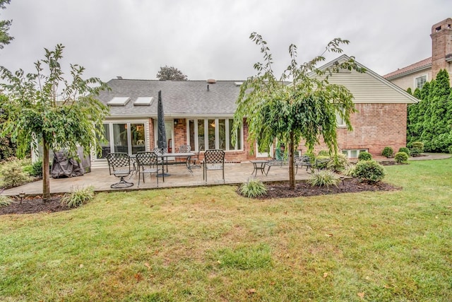 21629 28th Ave, Bayside, NY 11360 - back of property featuring a lawn, a patio, and brick siding