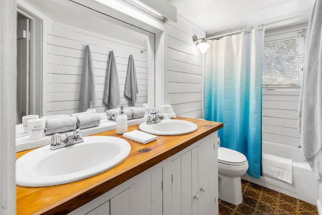 bathroom featuring toilet, double vanity, a sink, and shower / bathtub combination with curtain