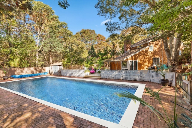 view of swimming pool with a patio, a fenced in pool, and a fenced backyard
