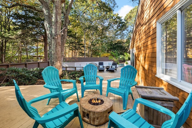 view of patio featuring fence, an outdoor fire pit, and a wooden deck