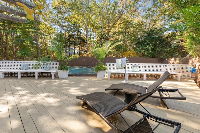 wooden terrace featuring fence