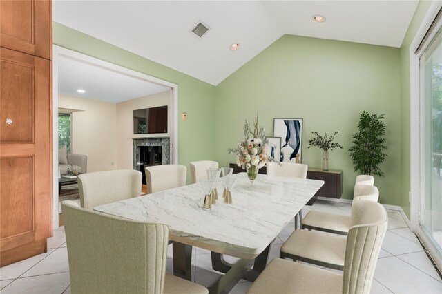 96 Mulberry Ave, Garden City, NY 11530 - dining area with light tile patterned floors, lofted ceiling, recessed lighting, and a fireplace