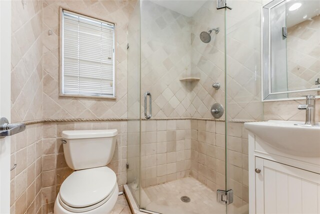 96 Mulberry Ave, Garden City, NY 11530 - full bathroom featuring tile walls, a shower stall, vanity, and toilet