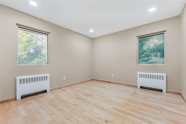 96 Mulberry Ave, Garden City, NY 11530 - empty room with radiator heating unit, wood finished floors, recessed lighting, and baseboards