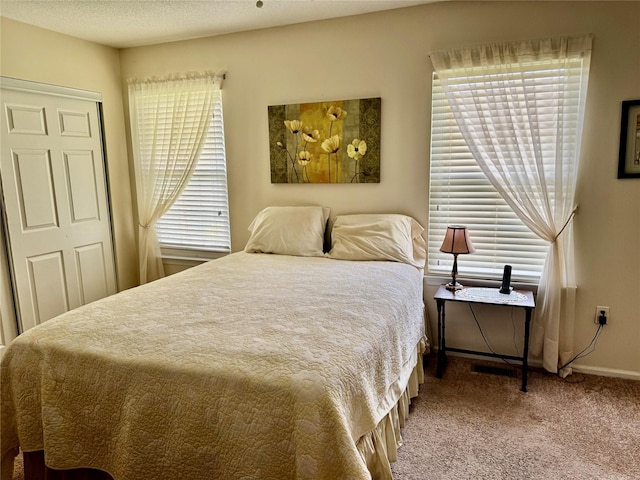 bedroom featuring a closet, carpet floors, and baseboards