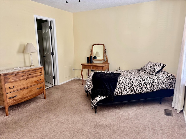 carpeted bedroom featuring visible vents