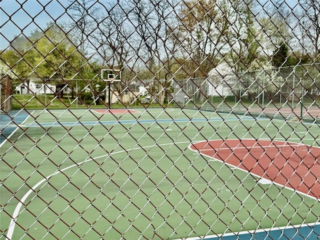 view of tennis court featuring fence